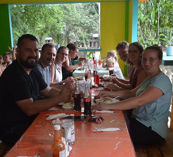 Belize Tour Guests Dining After Adventure with Hilario Adventure Tours Tour guests enjoying a traditional Belizean meal together after a day of adventure with Hilario Adventure Tours.